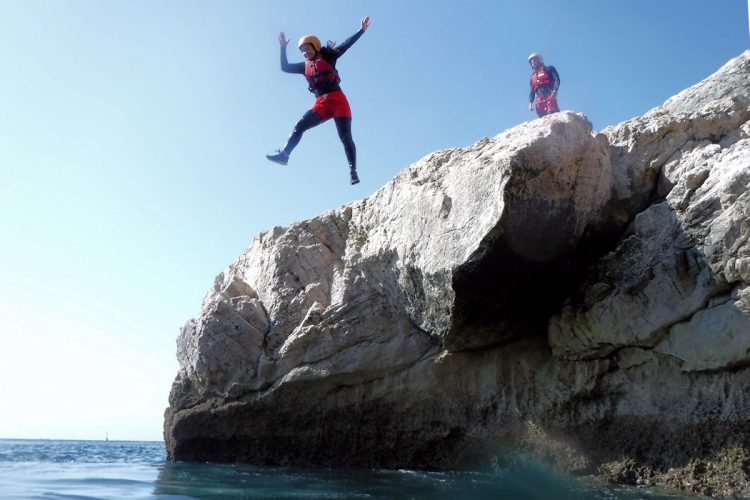 An Ocean Villas guest leaping into the Atlantic waters