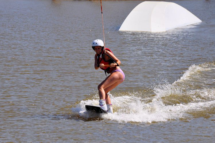 An Ocean Villas guest having a Wakeboarding lesson