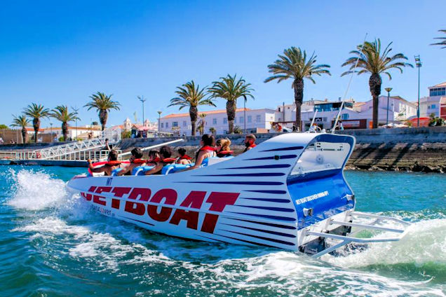 A jet boat tour with excited guests zooming out of Lagos Marina
