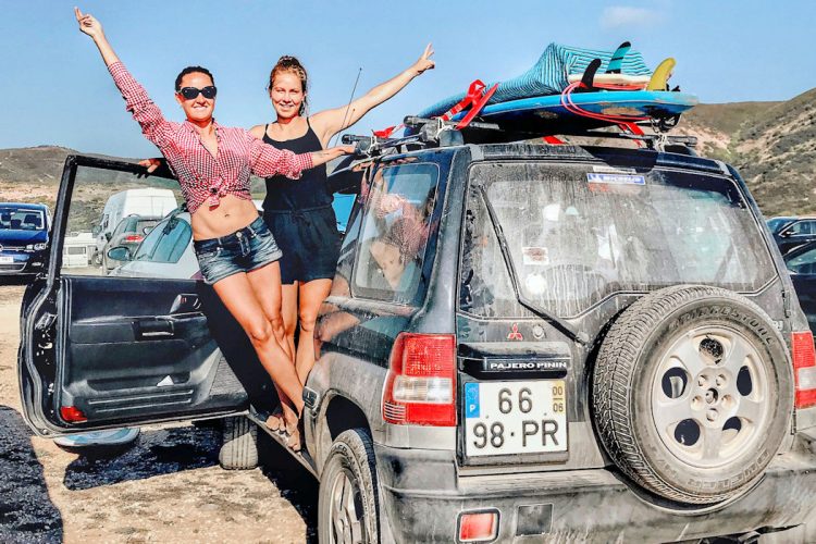 Surfers leaning out of their surf van near Amado beach