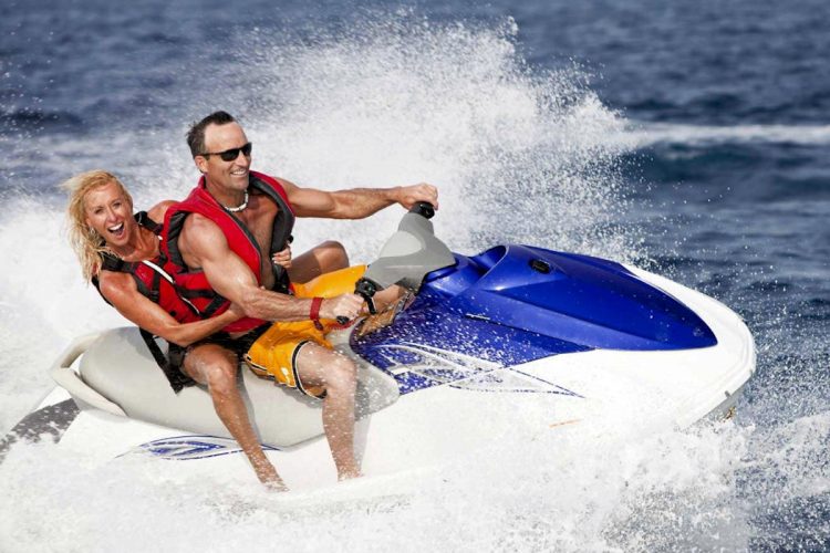 Two excited AltaVista guests try a jet ski in Luz near Lagos