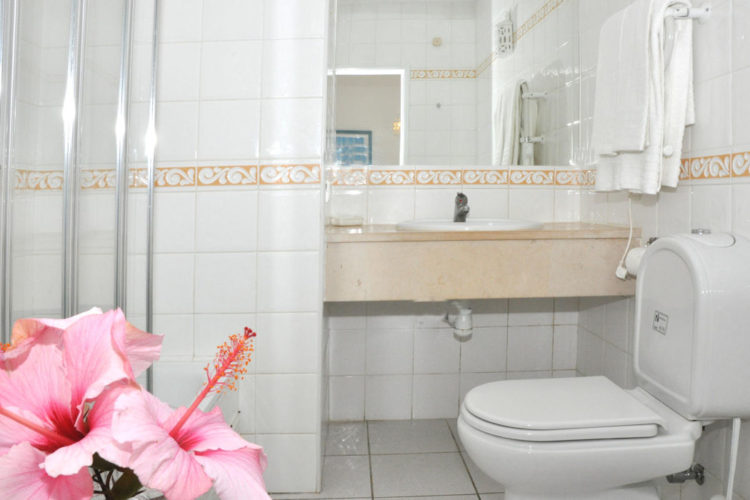 The white tiled bathrooms at Ocean Villas Luz are clean and modern. They offer a stand up shower
