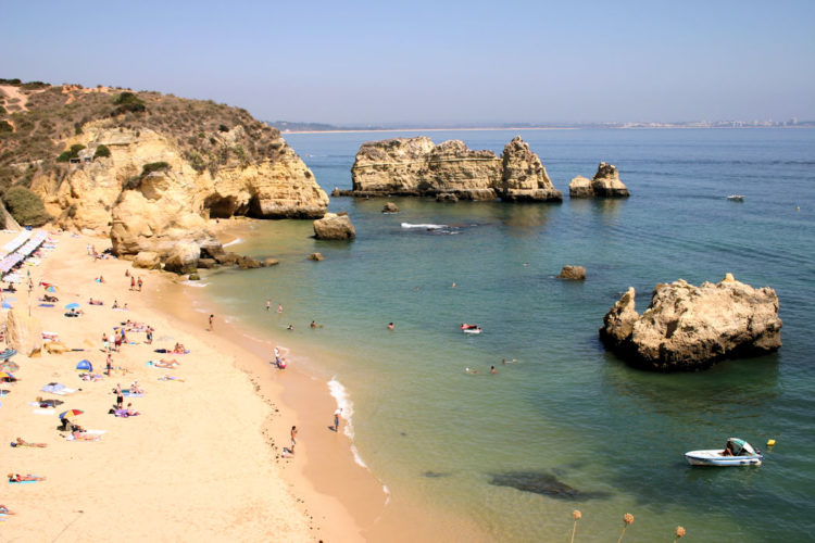 The clarity of the water around Praia Dona Ana is remarkable and looks stunning against the golden sandy beach