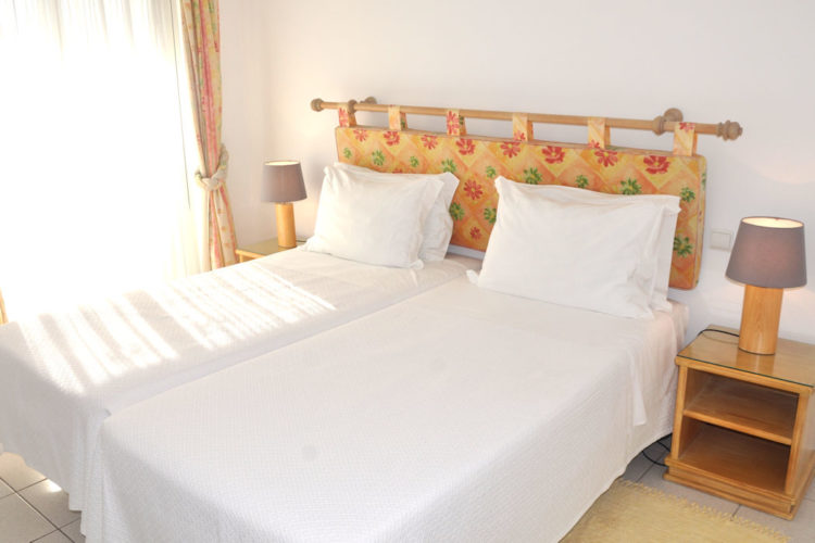 twin beds in the two bedroom villas with double doors that open onto the terrace