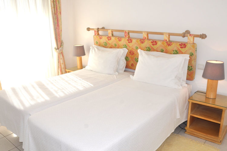 OV2 Bedroom 1 1050x700 twin beds in the two bedroom villas with double doors that open onto the terrace