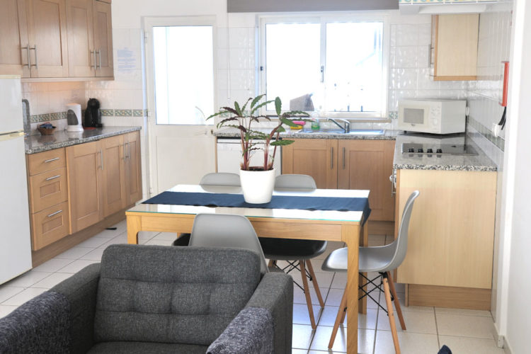 The kitchen in leads out onto a few steps that lead up to the swimming pool