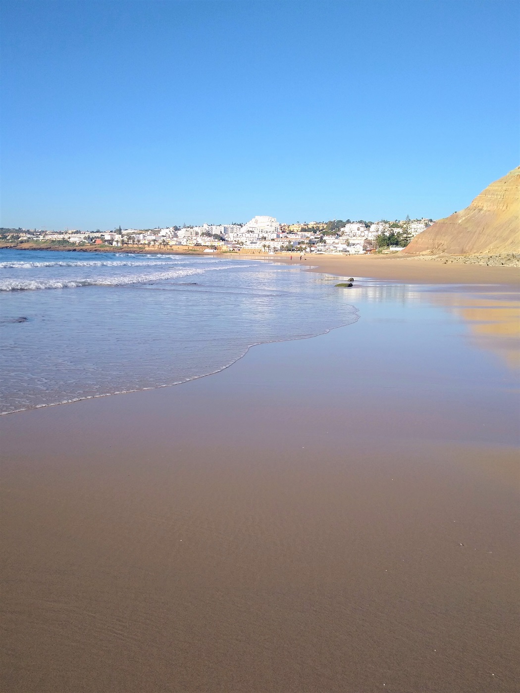 The reflections on the sand of the main beach at Praia da Luz.