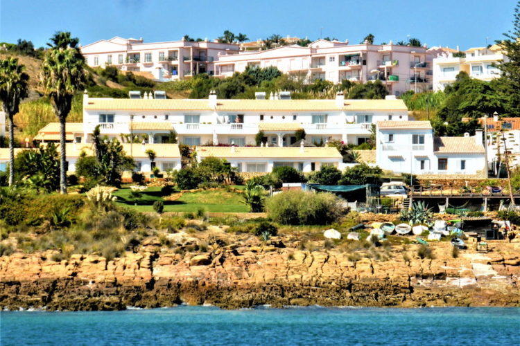 The gardens and oceanfront holiday villas of Ocean Villas Luz as viewed from the sea. Two minutes walk from Praia da Luz